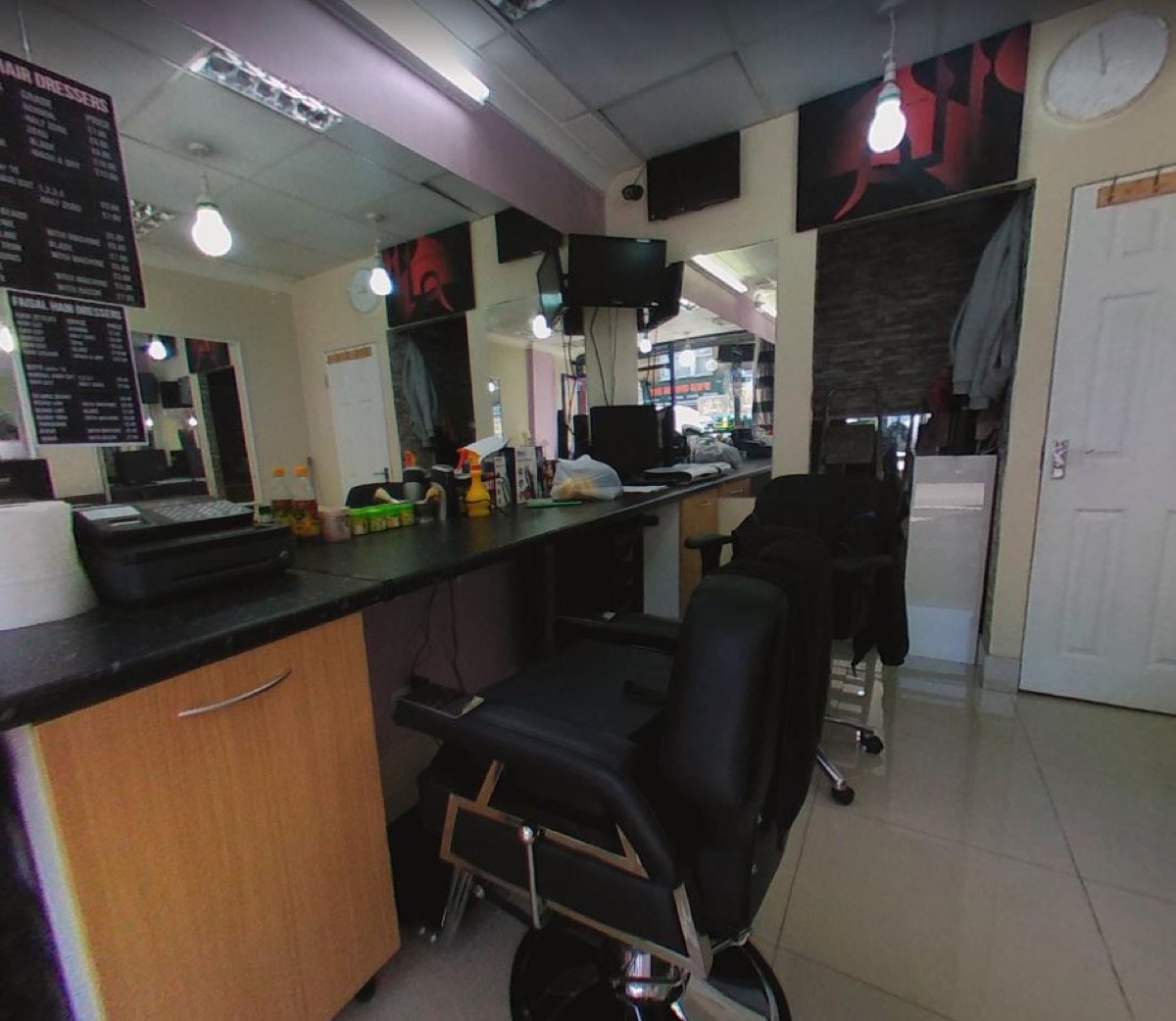 Inside Faisal Hairdressers on Upton Lane — barber chairs, wall mirrors and the price boards